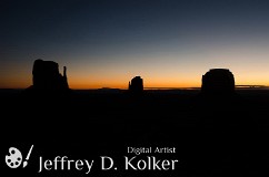 Monument Valley Sunrise Early morning in Monument Valley, Arizona. Literally at the crack of dawn, the sun begins to rise, illuminating the sky behind the famous stone monuments,...