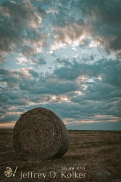 Hay Bale at Dusk A lone hay bale sits in a field near Pryor, Oklahoma as clouds gather for an incoming storm.